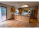 Bright kitchen featuring wood cabinets, a stainless steel refrigerator and a sliding glass door to the backyard at 7334 S Moore St, Littleton, CO 80127