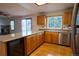 Kitchen features wood cabinets, stainless steel dishwasher, and spacious countertops at 7334 S Moore St, Littleton, CO 80127