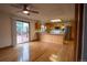 Bright kitchen featuring wood cabinets, a stainless steel refrigerator and a sliding glass door to the backyard at 7334 S Moore St, Littleton, CO 80127