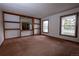 Bright living room with large windows and built-in shelving, perfect for entertaining or relaxing at 7334 S Moore St, Littleton, CO 80127
