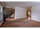 Living room featuring hardwood flooring, staircase, and neutral walls at 7334 S Moore St, Littleton, CO 80127