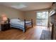 Cozy main bedroom featuring hardwood floors, a skylight and a fireplace at 7334 S Moore St, Littleton, CO 80127