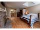 Bright main bedroom with hardwood floors, fireplace, and ensuite bathroom with double sinks at 7334 S Moore St, Littleton, CO 80127