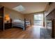 Bedroom featuring hardwood floors, skylight and sliding glass door access to a private deck at 7334 S Moore St, Littleton, CO 80127
