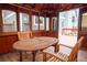 Cozy covered patio featuring a wood table and chairs, perfect for relaxation and outdoor dining at 7334 S Moore St, Littleton, CO 80127