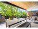 Covered back porch with table, bench and assorted chairs at 2669 N Cherry St, Denver, CO 80207