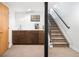 Finished basement with kitchenette and staircase to upper level at 2669 N Cherry St, Denver, CO 80207