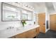 Stylish bathroom featuring a double vanity, sleek fixtures, and modern tile flooring at 2669 N Cherry St, Denver, CO 80207