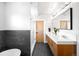 Modern bathroom showcasing a dual vanity, sleek tiling, and a luxurious soaking tub at 2669 N Cherry St, Denver, CO 80207