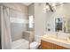 Modern bathroom with gray tiling, a bathtub, and a stylish vanity with a sink at 2669 N Cherry St, Denver, CO 80207