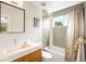 Bathroom featuring grey tiles, large mirror, single sink vanity, tub, and shower at 2669 N Cherry St, Denver, CO 80207