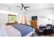 Bright bedroom boasting sleek ceiling fan, warm wood floors, and ample closet space at 2669 N Cherry St, Denver, CO 80207