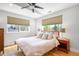 Bright bedroom with many windows, ceiling fan and hardwood floors at 2669 N Cherry St, Denver, CO 80207