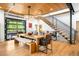 Stylish dining area featuring a large table, unique light fixture, and industrial staircase at 2669 N Cherry St, Denver, CO 80207
