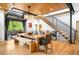 Stylish dining area featuring a large table, unique light fixture, and industrial staircase and open patio at 2669 N Cherry St, Denver, CO 80207