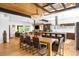 Bright dining room with a long wooden table, chandelier, and an open concept design with access to the kitchen at 2669 N Cherry St, Denver, CO 80207