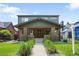 Charming two-story home with covered porch and manicured lawn at 2669 N Cherry St, Denver, CO 80207