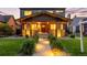 Stunning two-story home with a brick facade, inviting front porch, and lush green lawn with inviting walkway at 2669 N Cherry St, Denver, CO 80207