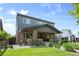 Charming two-story home with a brick and gray exterior, inviting front porch, and well-maintained front yard at 2669 N Cherry St, Denver, CO 80207