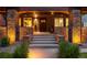 Inviting front porch with brick columns, stone steps, and a beautiful wood door with sidelights at 2669 N Cherry St, Denver, CO 80207