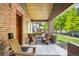 Relaxing front porch with comfortable seating, brick columns, and a view of the neighborhood street at 2669 N Cherry St, Denver, CO 80207