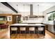 Modern kitchen with stainless steel appliances, eat-in island, and stylish barstool seating at 2669 N Cherry St, Denver, CO 80207