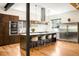 Modern kitchen with stainless steel appliances, an eat-in island, and custom cabinetry at 2669 N Cherry St, Denver, CO 80207