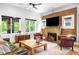Charming living room boasting a brick fireplace, comfortable seating, and an abundance of natural light at 2669 N Cherry St, Denver, CO 80207
