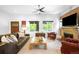 Inviting living room showcasing a brick fireplace, comfortable seating, and lots of natural light at 2669 N Cherry St, Denver, CO 80207