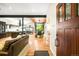 Bright open-concept living space with hardwood floors, modern kitchen, and seamless flow to the dining area at 2669 N Cherry St, Denver, CO 80207