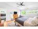 Bright main bedroom with ample natural light, modern furnishings, and sleek ceiling fan at 2669 N Cherry St, Denver, CO 80207