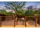 Outdoor patio area featuring a fire pit, stainless steel grill, and surrounded by lush landscaping and mature trees at 2669 N Cherry St, Denver, CO 80207