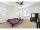 Bright bedroom featuring a ceiling fan, carpeted floors, and natural light from the windows at 22863 E Tufts Ave # A, Aurora, CO 80015