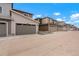 Townhome exteriors featuring attached garages, concrete driveways, and nicely coordinated color palettes at 22863 E Tufts Ave # A, Aurora, CO 80015