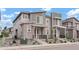 Attractive townhouse with contemporary gray siding, stone accents, a small front porch, and low-upkeep landscaping at 22863 E Tufts Ave # A, Aurora, CO 80015