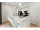 Kitchen island with sleek white countertops, stainless steel appliances, and modern pendant lighting at 22863 E Tufts Ave # A, Aurora, CO 80015