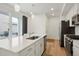 Modern kitchen features a large island with quartz countertops and stainless steel appliances at 22863 E Tufts Ave # A, Aurora, CO 80015