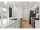 Modern kitchen area with stainless steel appliances, a large island, and ample natural light from sliding doors at 22863 E Tufts Ave # A, Aurora, CO 80015