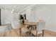 Eat-in kitchen area featuring a round table, modern light fixtures, and views into the full kitchen at 22863 E Tufts Ave # A, Aurora, CO 80015