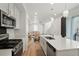 An open-concept view showcases the kitchen, dining, and living spaces, bathed in natural light at 22863 E Tufts Ave # A, Aurora, CO 80015