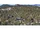 Aerial view of the property surrounded by lush greenery and mountain scenery at 29691 Fairway Dr, Evergreen, CO 80439