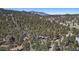 Breathtaking aerial shot of a wooded lot with mountain views at 29691 Fairway Dr, Evergreen, CO 80439