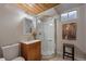 Bathroom with a glass-enclosed shower, modern fixtures, and a wood vanity at 29691 Fairway Dr, Evergreen, CO 80439
