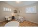 Charming bedroom with hardwood floors, natural light from shuttered windows, and a decorative floral accent at 29691 Fairway Dr, Evergreen, CO 80439