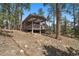 A welcoming exterior view of the home featuring a large deck for outdoor living at 29691 Fairway Dr, Evergreen, CO 80439