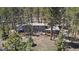 An aerial view of the home reveals mature trees, a deck, and a gray exterior at 29691 Fairway Dr, Evergreen, CO 80439