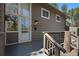 A warm welcome awaits at the front door, complete with a welcome mat and wood accents at 29691 Fairway Dr, Evergreen, CO 80439