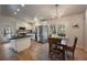 Open-concept kitchen featuring black counters, a dining area, and stainless steel appliances at 29691 Fairway Dr, Evergreen, CO 80439