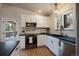Updated kitchen featuring stainless steel appliances, white cabinetry and black countertops at 29691 Fairway Dr, Evergreen, CO 80439
