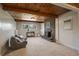Inviting living room features wood beam ceiling, fireplace and plush seating for a cozy gathering spot at 29691 Fairway Dr, Evergreen, CO 80439